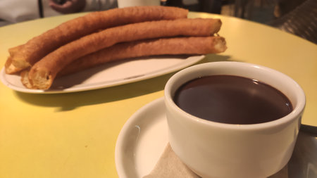 Traditional Spanish dessert churros with sugar and chocolateの写真素材