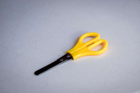 scissors with yellow cable on white backgroundの写真素材