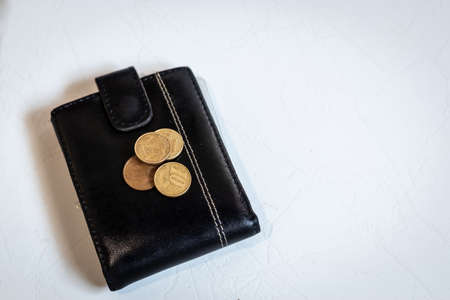 coins on top of a wallet, isolated on white backgroundの写真素材