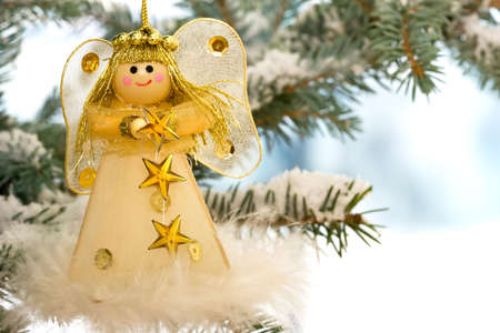 Christmas Angel on a snow encrusted treeの写真素材
