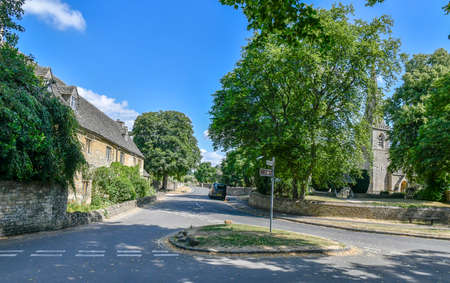 LOWER SLAUGHTER, THE COTSWOLDS, GLOUCESTERSHIRE, ENGLAND - JULY 14th 2018: Cotswold stone cottages ...