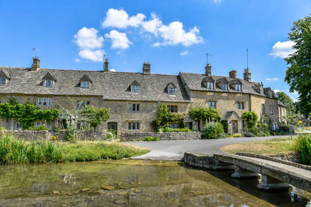 LOWER SLAUGHTER, THE COTSWOLDS, GLOUCESTERSHIRE, ENGLAND - JULY 14th 2018: Cotswold stone cottages ...