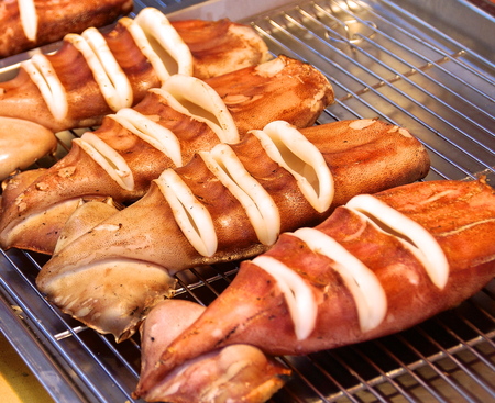 BBQ with roasted squid on a grillの写真素材