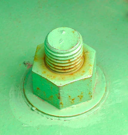 Green paint of rusty nut and bolt の写真素材