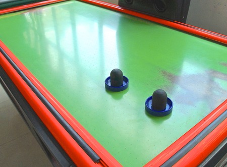 Air hockey table closeup with paddle at amusement arcadeの写真素材
