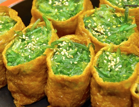 Closeup of sushi with kelp sprout in restaurantの写真素材