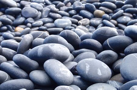 The hard pebbles closeup on the beach