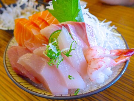 Japanese Sashimi with raw fish at restaurantの写真素材