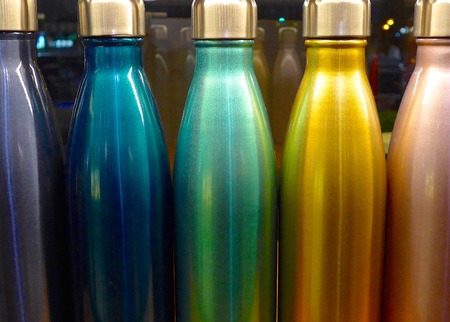A row of colored bottles at bar