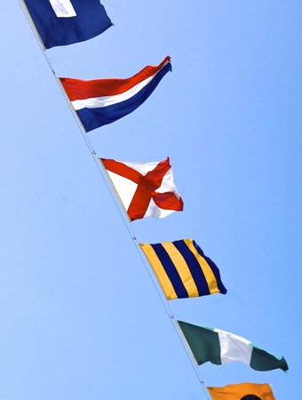 The row of nautical flags closeup on ship