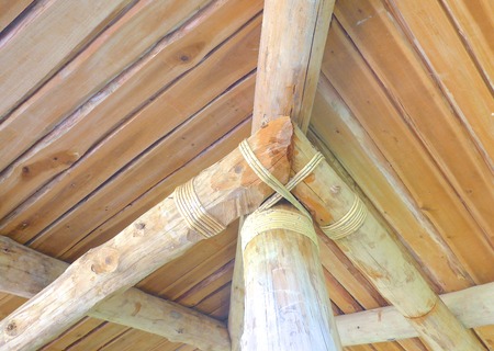 Wooden logs roof with rope closeupの写真素材