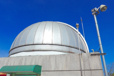 Astronomical observatory dome closeup in blue skyの写真素材