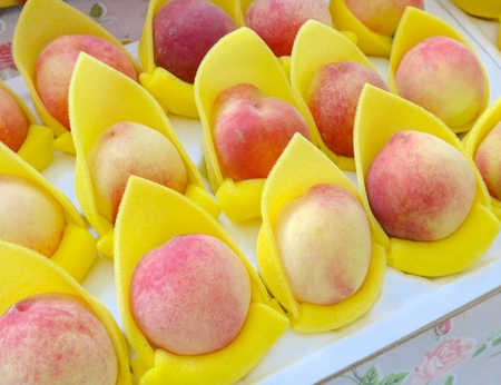 Juicy peaches close up at the marketの写真素材