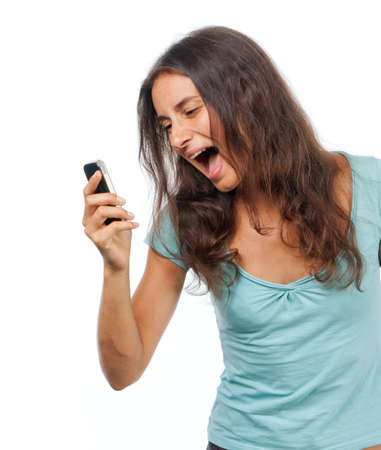 Emotional pretty girl screams to mobile phoneの写真素材