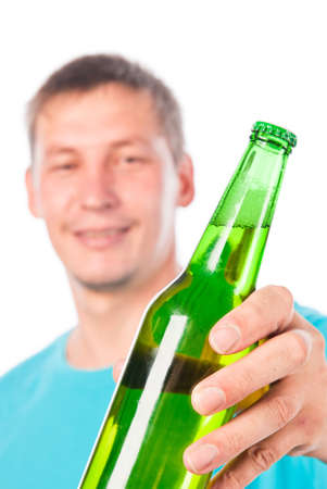 Smiling young man offer beer bottleの写真素材