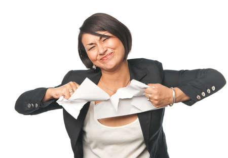 Angry young businesswoman tearing paperの写真素材