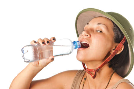 Girl in a pith helmet with a bottle of waterの写真素材