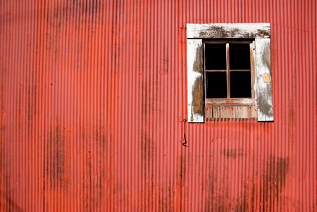 the side of a red bard and its window