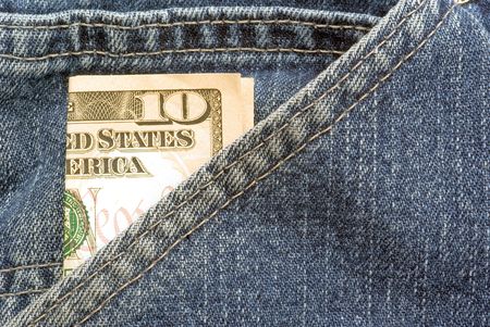 A US ten dollar bill sticking out of a pocket