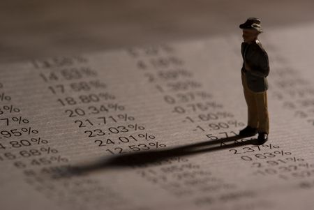 The shadow of a figure going across a financial reportの写真素材