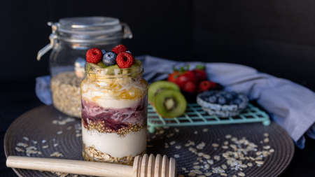 granola with fruit and honey. dark food photographyの写真素材