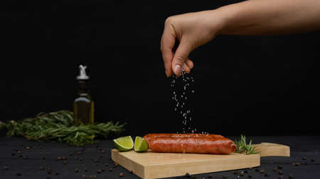 sausage with salt, spices and olive oil, black backgroundの写真素材