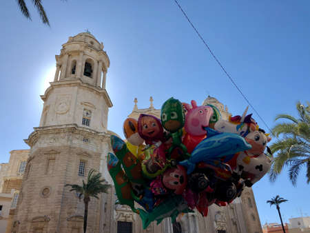 Bunch of balloons in front of cathedral of cadiz, south of Spain. Photo taken during carnivals fests.の写真素材