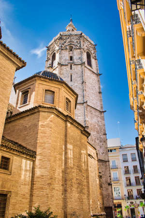 Street and side of the cathedral of Valencia with its bell tower of Micaletの写真素材