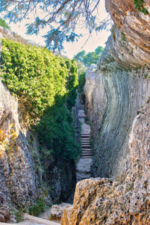 Narrow corridor between rocky walls and with stairs, called El Tobogan in La Ciudad Encantada de Cuencaの写真素材