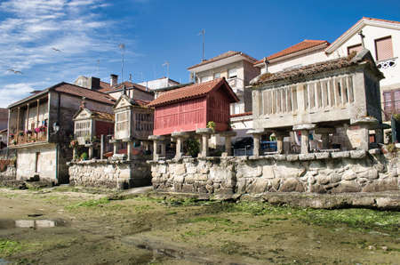 Beautiful traditional Galician granaries on the seashore at low tide in Combarro, Spain