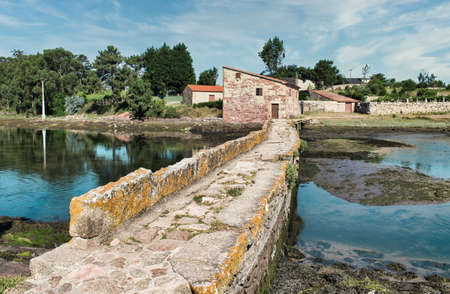 Narrow stone bridge and A Seca tidal mill in the town of Cambados, Spainの写真素材