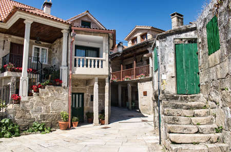 Beautiful narrow street of low buildings and stone architecture in the village of Combarro,...