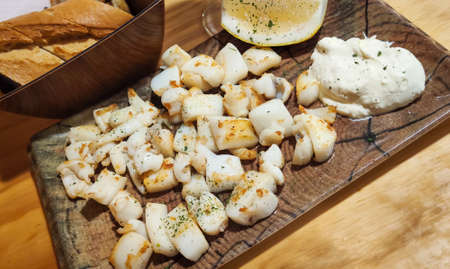 Portion of grilled cuttlefish with mayonnaise ali oliの写真素材