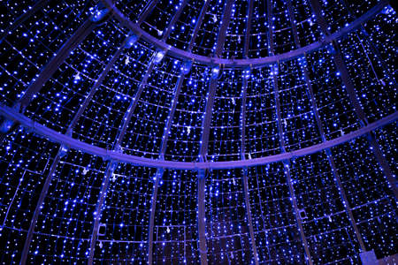 Infinity of light bulbs illuminating a large Christmas ball seen from within in Valladolidの写真素材