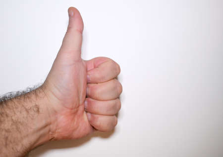 Caucasian adult man's hand with thumb up