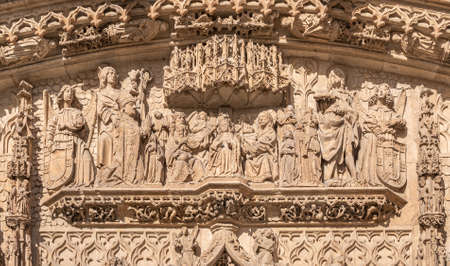 Close-up of the scene of the coronation of the Virgin, in the presence of Fray Alonso de Burgos kneeling on the faÃ§ade of the San Pablo church in Valladolid, Spainの写真素材
