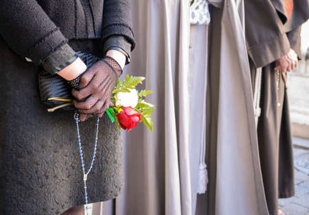 Holy Week Valladolid, detail of floral motif in the hands of a woman during Holy Saturdayの写真素材