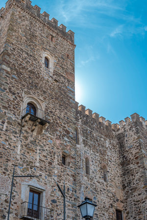 Vertical shot of crenellated towers of the Royal Monastery of Guadalupe, 14th century, Spain