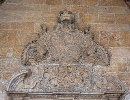Ancient stone shield over the entrance door to the chapter house of the cathedral of Oviedo, Spainの写真素材