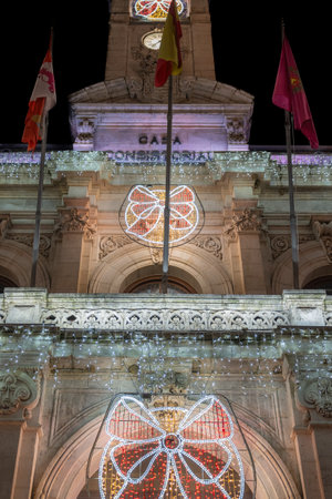 Vertical photograph detail of the facade of the Valladolid City Hall illuminated with Christmas lights, Spainの写真素材