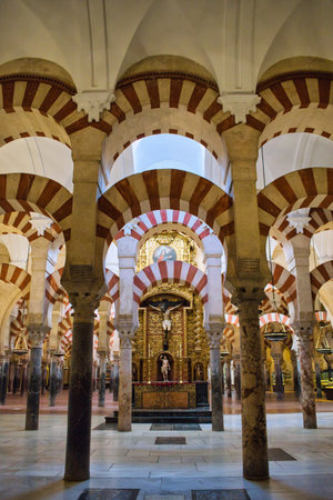 Altar with Jesus Christ crucified in the forest of columns and Moorish arches of the Mosque Cathedral of Cordoba, Spainの写真素材