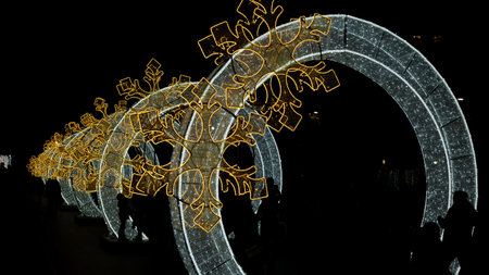 Beautiful and bright arches of sparkling Christmas lights next to the cathedral in Valladolid, Spainの写真素材