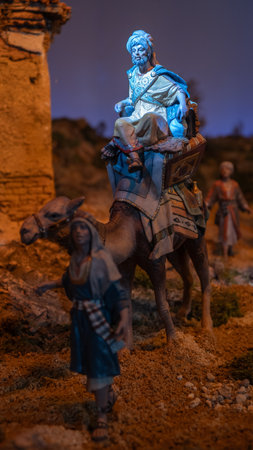 Vertical photo of a figure for a nativity scene at Christmas. The Three Wise Men riding a camel. Bible, decoration, religionの写真素材