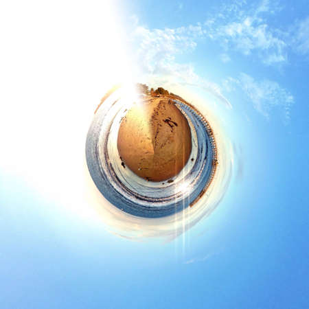 Abstract globe with beach and city skyline at sunset!の素材