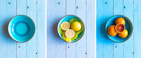 Colorful Orange fruits over a light blue painted wood table with a simmetric position.
