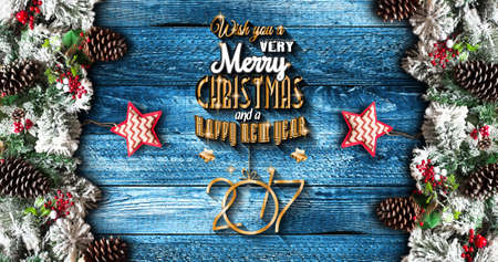 2017 New Year  Frame with green pine, colorful baubles, knots with berries,stars and other seasonal stuff over an old wooden aged backgroundの写真素材