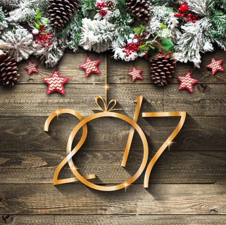 2017 New Year  Frame with green pine, colorful baubles, knots with berries,stars and other seasonal...