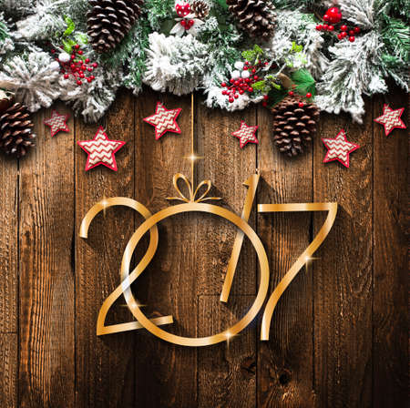 2017 New Year  Frame with green pine, colorful baubles, knots with berries,stars and other seasonal...