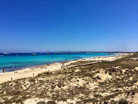 Beatiful Sunny Beach day in Formentera Spain in the middle of the holiday summer season.の写真素材