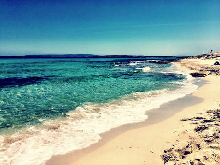 Beatiful Sunny Beach day in Formentera Spain in the middle of the holiday summer season.の写真素材